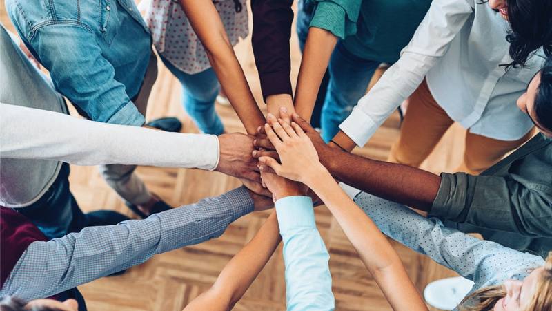 Connected hands stacked — you don't need to find help alone