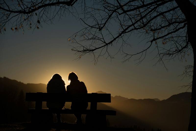 Two locals talking at sunset — the right voice is someone already trusted